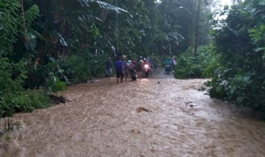 Warga Desa Bajo Bahari Bersama Anggota Kepolisian Bantu Warga yang Terjebak Genangan Air